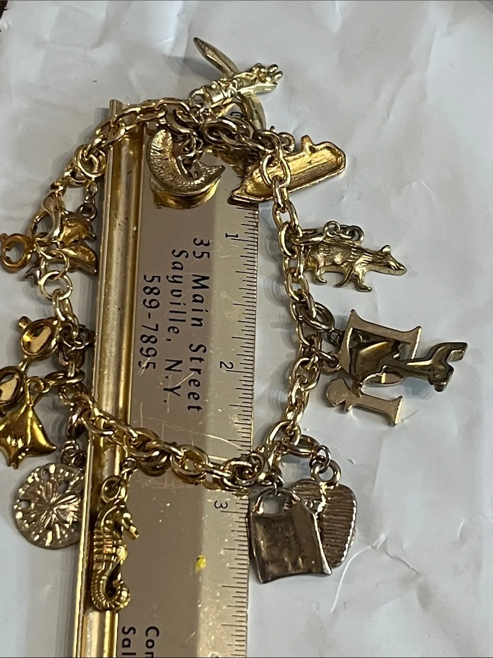 DIAMOND INTERNATIONAL GOLDTONE CHARM BRACELET